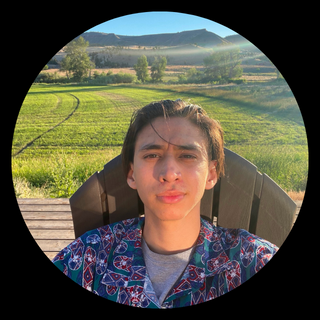 Student sitting in chair in front of mountains